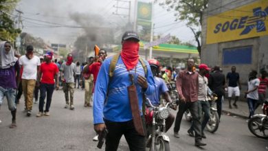 Armed off duty police officers protest over police pay and working conditions in Port au Prince