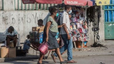 Two people in the Haitian capital Port au Prince wear face masks credit AFP Pierre Michel Jean