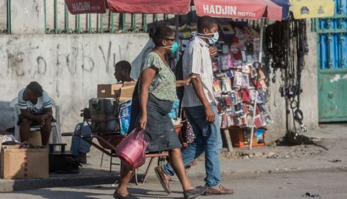 Two people in the Haitian capital Port au Prince wear face masks credit AFP Pierre Michel Jean